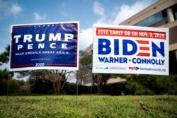 Yard signs supporting U.S. President Donald Trump and Democratic U.S. presidential nominee and former Vice President Joe Biden are seen outside of an early voting site at the Fairfax County Government Center in Fairfax, Virginia