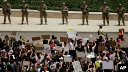 Demonstrators gather at police headquarters in downtown Kansas City, Mo., June 5, 2020, as they protest the death of George Floyd who died after being restrained by Minneapolis police officers on May 25.