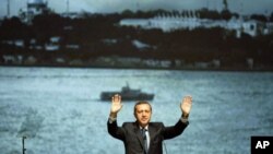 Turkey's Prime Minister Recep Tayyip Erdogan greets the audience during a campaign event for the upcoming general elections in Istanbul, April 27, 2011