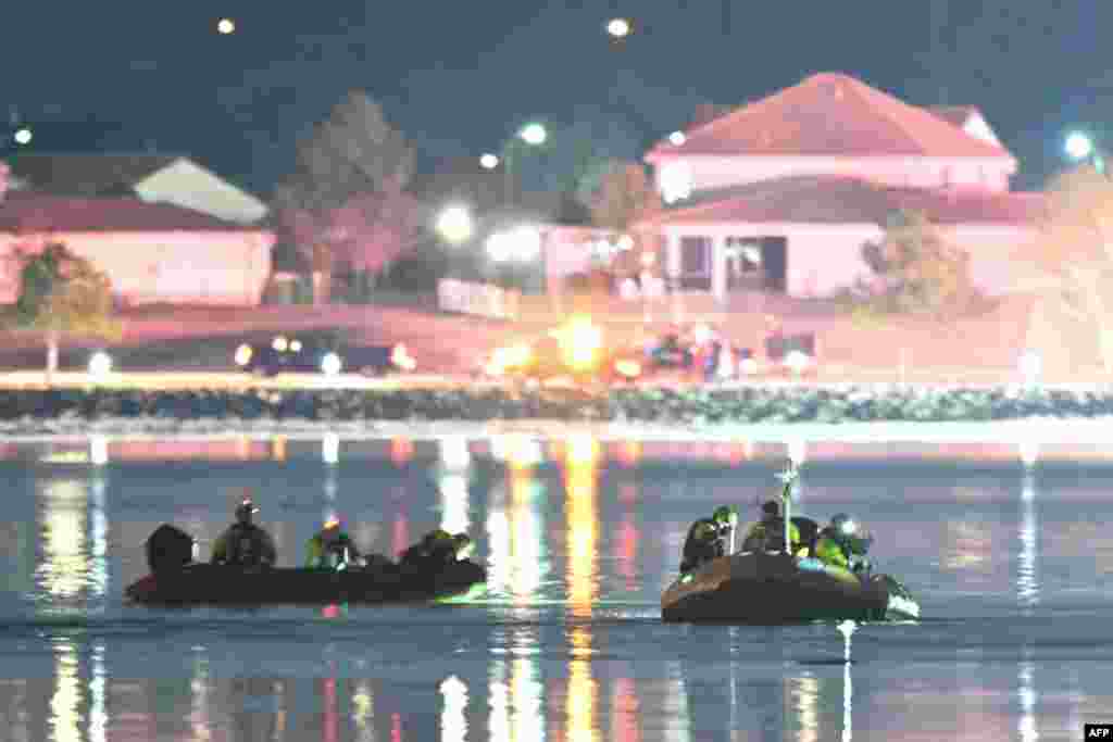 Rescue boats search the waters of the Potomac River after a plane on approach to Reagan National Airport crashed into the river outside Washington, Jan. 30, 2025.