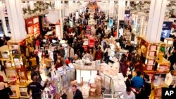 Shoppers take advantage of Black Friday door buster deals at Macy's Herald Square, Nov. 24, 2016, in New York.