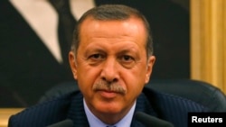 Turkey's Prime Minister Tayyip Erdogan addresses the media before he leaves for Turkmenistan at Esenboga Airport in Ankara, Aug. 15, 2013. 