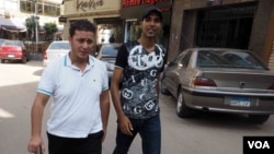 Once physically female, Mohammad Alaam (L) and his friend stroll through a Cairo suburb, June 13, 2016. (H. Elrasam/VOA)