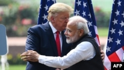 FILE - President Donald Trump shakes hands with India's Prime Minister Narendra Modi during a joint press conference at Hyderabad House in New Delhi, Feb. 25, 2020.