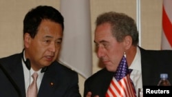 FILE - U.S. Trade Representative Michael Froman (R) speaks with Japan's Economics Minister Akira Amari as they take their seats before a news conference with other pacific rim ministers to conclude the Trans-Pacific Partnership (TPP) Ministerial meeting i