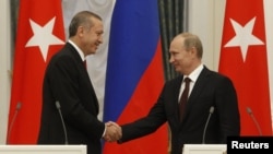 Rossiya prezidenti Vladimir Putin (o'ngda) Kremlda Turkiya Bosh vaziri Rajab Toyib Erdog'anni qabul qilmoqda, 18-iyul, 2012-yil;. 