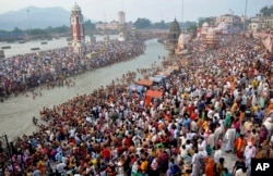 Hindu devotees gather on the banks of the River Ganges to take holy dips on the auspicious occasion of Somvati Amavasya in Haridwar, India, Monday, May 18, 2015.