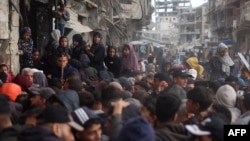 Palestinians line up to receive bread outside a bakery in Khan Yunis, Nov. 18, 2024, amid the ongoing war between Israel and Hamas.