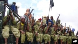FILE - Al-Shabab fighters sit on a truck as they patrol in Mogadishu, Somalia, Oct. 30, 2009.