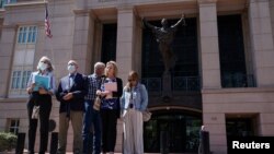 والدین پیتر کاسیگ و کایلا مولر، دو آمریکایی که به دست شبه‌نظامیان داعش کشته شدند، روز ۲۸ مرداد ۱۴۰۱ پس از صدور حکم حبس ابد برای الشافی الشیخ، از اعضای داعش، در شهر الکساندریا، ایالت ویرجینیا، حضور پیدا کرده‌اند. (عکس از رویترز)