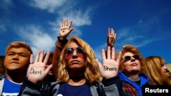 Baadhi ya watu waliohudhuria mkutano mkubwa uliofanyika mjini Washington DC Jumamosi Machi 24, 2018, wakati wa maandamanio ya kuhamasisha juu ya udhibiti umiliki wa bunduki Marekani.