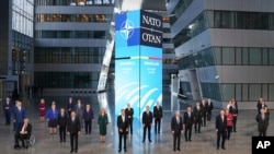 President Joe Biden and other NATO heads of the states and governments pose for a family photo during the NATO summit at the Alliance's headquarters, in Brussels, Belgium, Monday, June 14, 2021. (Kevin Lamarque/Pool via AP)
