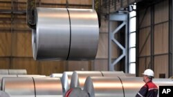 FILE - A worker moves steel coils at the Thyssenkrupp steel factory in Duisburg, Germany, April 27, 2018. German reaction to the announcement of U.S. tariffs being placed on steel and aluminum imports was among the fiercest in Europe.