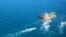 A picture obtained by AFP from the Iranian news agency Tasnim on Jan. 4, 2021, shows the South Korean-flagged tanker being escorted by Iran's Revolutionary Guards navy after being seized in the Gulf.