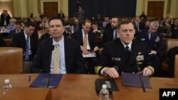 FBI Director James Comey (L) and National Security Agency Director Mike Rogers (R) arrive to speak during the House Permanent Select Committee on Intelligence hearing on Russian actions during the 2016 election campaign on March 20, 2017. (AFP PHOTO / Nicholas Kamm)