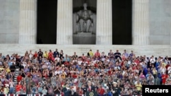 President Donald Trump and first lady Melania Trump arrive at an Independence Day celebration in front of the Lincoln Memorial in Washington, July 4, 2019. 