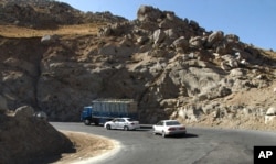 Vehicles take a sharp turn on a troubled highway near Pol-I-Kumari, Afghanistan, along the one time Silk Road route. Growing Taliban influence in northern Afghanistan is threatening the new military supply line painstakingly negotiated by the U.S.,