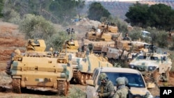 FILE - Turkish troops take control of Bursayah hill, which separates the Kurdish-held enclave of Afrin from the Turkey-controlled town of Azaz, Syria, Jan. 28, 2018. 