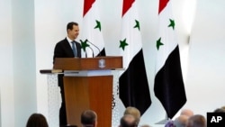 In this photo released by the official Facebook page of the Syrian presidency, Bashar al-Assad speaks after being sworn in for a fourth seven-year term, at the Syrian Presidential Palace in Damascus, July 17, 2021.
