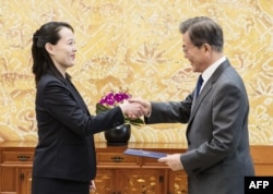 FILE - North Korean leader Kim Jong Un's sister Kim Yo Jong hands an autographed letter from Kim Jong Un to South Korea's President Moon Jae-in during their meeting at the presidential Blue House in Seoul, Feb. 10, 2018.
