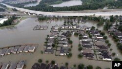Homes are surrounded by floodwaters from Tropical Storm Harvey, Aug. 29, 2017, in Spring, Texas. Congress is considering renewing the National Flood Insurance Program.