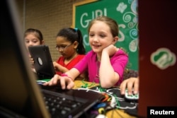 A Girl Scout works on a laptop computer, in a photo released June 21, 2017.