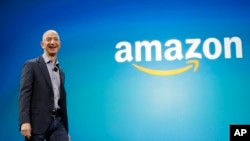 FILE - Amazon CEO Jeff Bezos walks onstage for the launch of the new Amazon Fire Phone, in Seattle. 