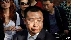 FILE - Human rights activist Jiang Tianyong speaks to journalists in Beijing, China, May 2, 2012. Jiang detained in connection with a sweeping crackdown on lawyers and activists stood trial Aug. 22, 2017, on charges of subversion of state power.