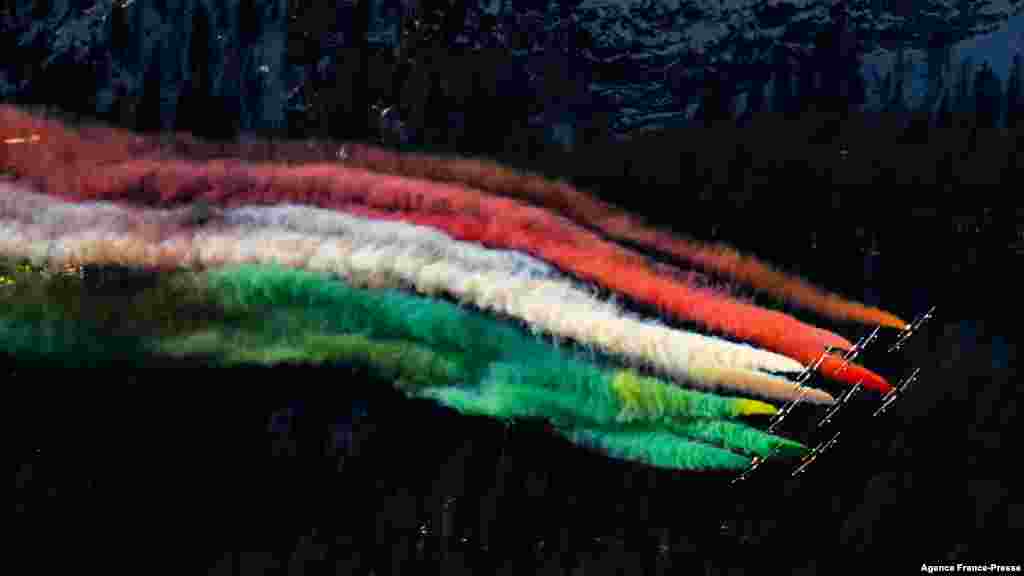 Planes of the Italian Air Force aerobatic unit Frecce Tricolori (Tricolor Arrows) perform over Alta Badia, Dolomite Alps, during the men's FIS Ski World Cup Giant Slalom event.