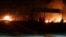 This photo released on May 9, 2018, by the Syrian official news agency SANA, shows flames rising after an attack in an area known to have numerous Syrian army military bases, in Kisweh, south of Damascus, Syria.