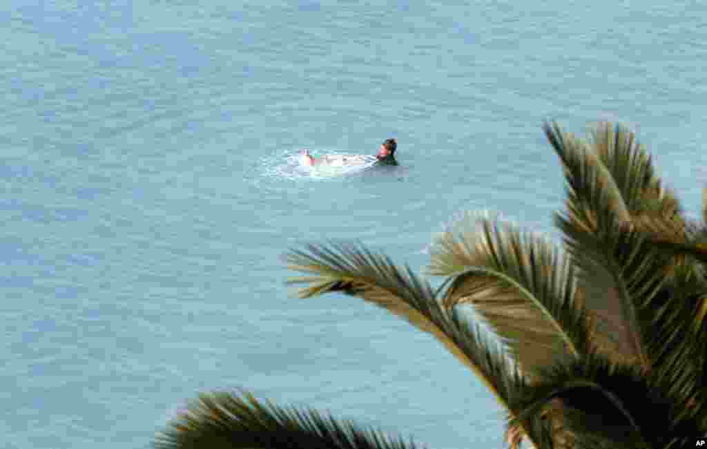 A woman swims in the Mediterranean Sea in Nice, southeastern France.