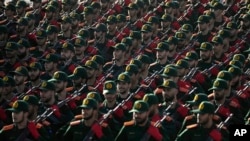 Cadets of Iran's Islamic Revolutionary Guard Corps march in a parade outside Tehran, Sept. 21, 2024. The U.S. on Sept. 27, 2024, filed charges against three members of the Guard, accusing them of hacking to interfere with U.S. elections.