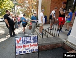 People arrive to cast their ballot for 2016 elections at a polling station as early voting begins in North Carolina, in Carrboro, North Carolina, Oct. 20, 2016.