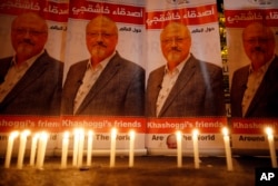 FILE - Candles, lit by activists, protesting the killing of Saudi journalist Jamal Khashoggi, are placed outside Saudi Arabia's consulate, in Istanbul, during a candlelight vigil, Oct. 25, 2018.