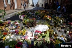 FILE - Flowers are pictured on the street where Heather Heyer was killed when a suspected white nationalist crashed his car into anti-racist demonstrators in Charlottesville, Virginia, U.S., Aug. 16, 2017.