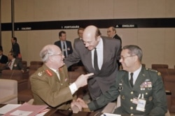 FILE - United Kingdom Chief of Staff Field Marshall Sir Richard Vincent, left, with NATO Secretary General Manfred Woerner and U.S. Chief of Staff Gen. Colin Powell, right, at the NATO Defense Minister meeting in Belgium, Dec. 12, 1991.
