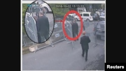 A still image taken from CCTV video and obtained by TRT World claims to show Saudi journalist Jamal Khashoggi, highlighted in a red circle by the source, as he stands with his fiancee Hatice Cengiz outside the Saudi Arabia's Consulate in Istanbul, Turkey.
