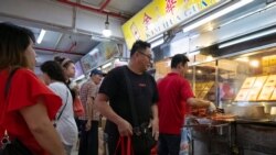 A customer leaves after collecting a bag of Bak Kwa, a traditional Southern Chinese pork jerky popular among Singaporean Chinese for Lunar New Year celebrations. Photo taken on January 18, 2020. REUTERS/Loriene Perera