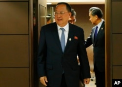 North Korean Foreign Minister Ri Yong Ho emerges from his bilateral meeting with his Chinese counterpart Wang Yi, right, in the sidelines of the 50th ASEAN Foreign Ministers' Meeting and its Dialogue Partners, Aug. 6, 2017 in Manila, Philippines.