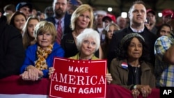 Supporters of Republican presidential candidate Donald Trump watch him speak during a campaign rally in Grand Rapids, Michigan, Oct. 31, 2016.