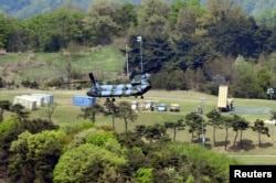 FILE - A Terminal High Altitude Area Defense (THAAD) interceptor (right) is seen in Seongju, South Korea, April 26, 2017.