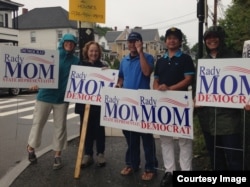 Supporters of Democratic Party candidate Rady Mom recently holding campaign signs.