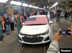 FILE - Employees watch as the last Chevrolet Cruze rolls off the assembly line at the General Motors Co assembly plant in Lordstown, Ohio, March 6, 2019, in this photo obtained from social media.