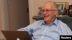 Harvard University professor Oliver Hart reads congratulatory emails after winning the 2016 Nobel Prize for Economics at his home.