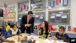 House Speaker Paul Ryan of Wis., talks to third grade Language Arts/Reading teacher Nadia Lorenzo-Luis during a visit atto Caribbean Elementary School, Wednesday, Oct. 19, 2016, in Miami. (AP Photo/Alan Diaz)