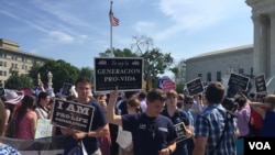 Pro-life demonstrators wave signs and make their voices heard after the Supreme Court upheld abortion rights in a 5-3 decision, in front of the Supreme Court building in Washington, June 27, 2016. (J. Oni / VOA News)