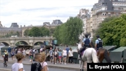 Bouquinistes line the left bank of the Seine River in Paris.