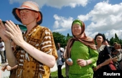 FILE - Participants march towards Mnazi Mmoja grounds during Tanzania Albino Day celebrations in Dar es Salaam.