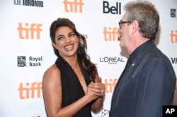 Actress Priyanka Chopra, left, chats with the director and CEO of TIFF Piers Handling at the TIFF Soiree, an annual fundraiser and celebratory kick-off for the 2017 Toronto International Film Festival, at the TIFF Bell Lightbox, Sept. 6, 2017, in Toronto.