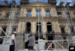 Workers erect scaffolding in front of Brazil's National Museum, in Rio de Janeiro, Brazil, Feb. 12, 2019.
